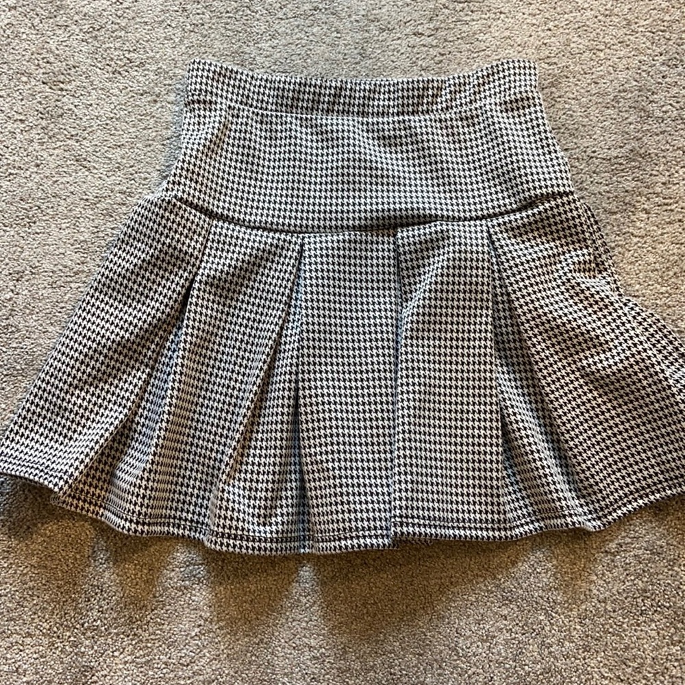 Caution to the wind black and white pleated mini skirt.